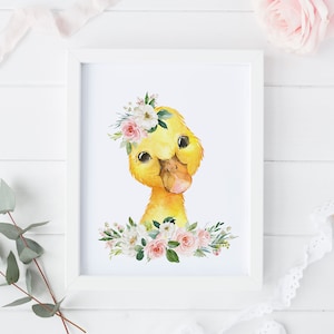 May include: A watercolor painting of a yellow duckling wearing a pink and white flower crown. The duckling is looking at the viewer with a sweet expression. The duckling is surrounded by pink and white flowers and green leaves.