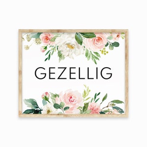 May include: A framed print with a white background and a floral design in shades of pink and green. The text "GEZELLIG" is printed in black in the center of the print.