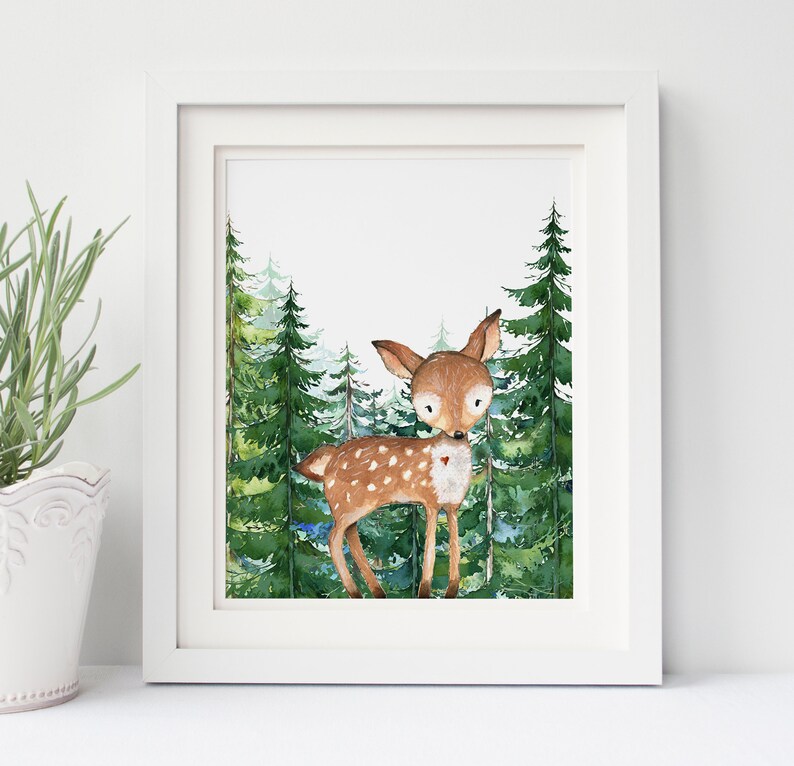 May include: A watercolor painting of a fawn standing in a forest. The fawn is brown with white spots and has a small red heart on its chest. The forest is made up of tall green pine trees.