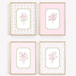 May include: Four framed floral prints. Each print features a bouquet of pink flowers within a green-bordered, rectangular frame. The backgrounds vary, including patterns of pink polka dots, stripes, and floral designs, all set within gold frames.