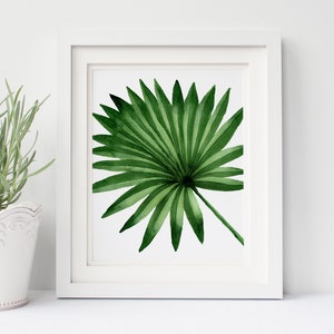 K&ouml;nnte beinhalten: Ein Aquarellbild eines einzelnen gr&uuml;nen Palmblattes, gerahmt in einem wei&szlig;en Rahmen.