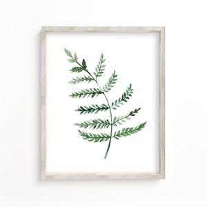 May include: A framed watercolor painting of a single green fern leaf on a white background.