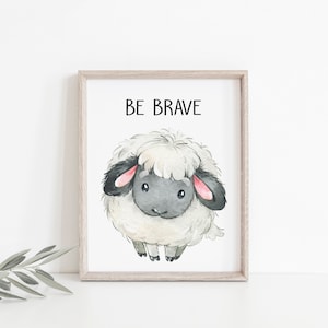 May include: A watercolor illustration of a white sheep with black ears and a black face. The sheep is looking at the viewer and has a cute expression. The text "BE BRAVE" is written above the sheep.