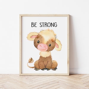 May include: A watercolor illustration of a brown and white calf with the text "BE STRONG" above it. The calf is sitting with its legs crossed and has a sweet expression on its face.