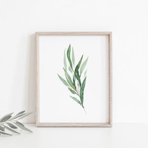 May include: A framed watercolor print of a green leafy branch with a white background.