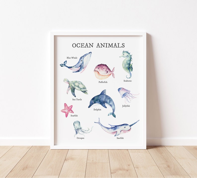 May include: A white framed print with the title "Ocean Animals" and illustrations of various sea creatures, including a blue whale, sea turtle, starfish, octopus, dolphin, jellyfish, pufferfish, seahorse, and sawfish.