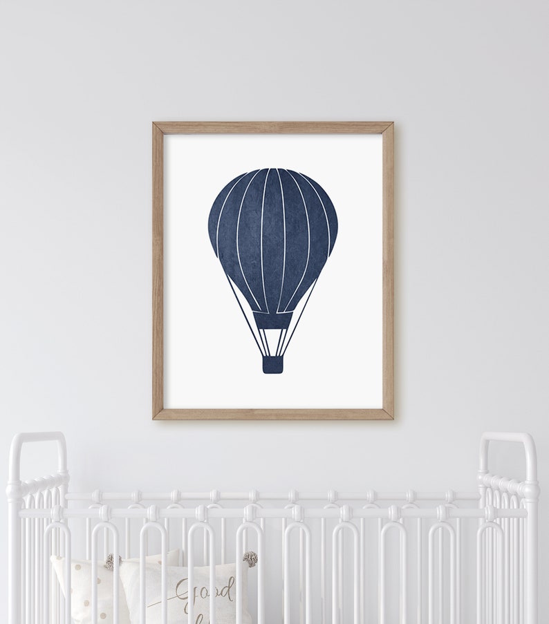 May include: A navy blue hot air balloon illustration in a wooden frame. The balloon has white lines and a white basket.