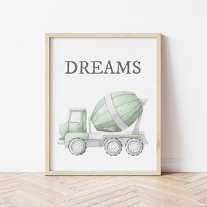 May include: Watercolor print of a green cement mixer truck with the word "DREAMS" in gray text. The truck has a light green cab and a rotating drum. The artwork is framed in a light wood frame.