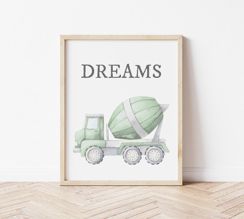 May include: Watercolor print of a green cement mixer truck with the word "DREAMS" in gray text. The truck has a light green cab and a rotating drum. The artwork is framed in a light wood frame.