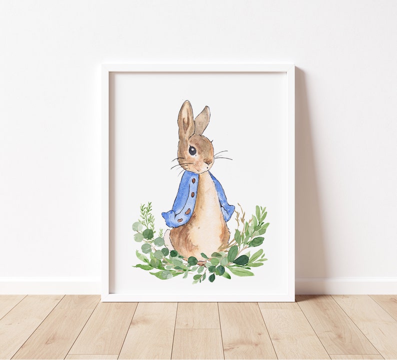 May include: A watercolor illustration of Peter Rabbit wearing a blue jacket and standing in a patch of green leaves.