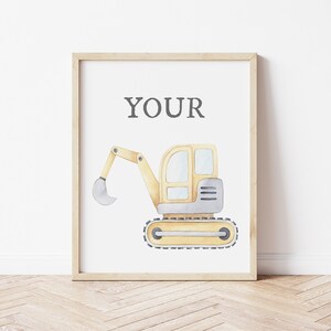 May include: Watercolor illustration of a yellow and gray excavator on a white background, framed in a light wood frame. The word "YOUR" is printed in gray at the top. The excavator is a construction-themed artwork.