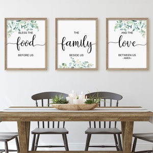 May include: Three framed prints with a watercolor background of green leaves. The prints have the text "Bless the food before us", "The family beside us", and "And the love between us - Amen - ".