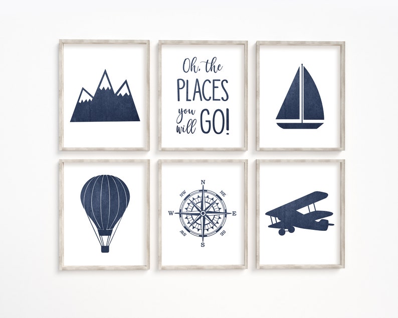 May include: Set of six blue and white framed prints with travel-themed illustrations. The prints feature a mountain range, a sailboat, a hot air balloon, a compass, an airplane, and the text "Oh, the places you will go!"