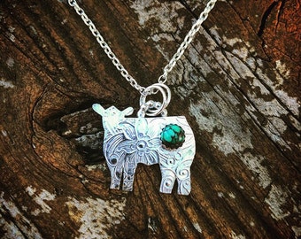 Sterling Silver textured Heifer with a genuine turquoise stone