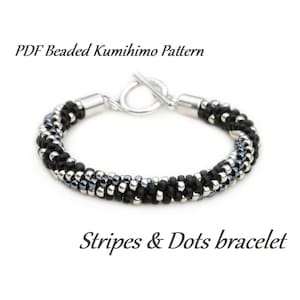 May include: Black and silver beaded bracelet with a toggle clasp. The bracelet has a striped and dotted pattern. PDF Beaded Kumihimo Pattern Stripes & Dots bracelet.