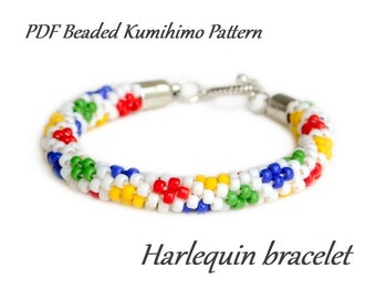 May include: A colorful beaded bracelet with a harlequin pattern. The bracelet is made with white, red, yellow, blue, and green beads. The bracelet has a silver clasp.