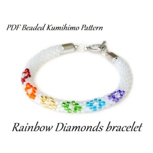 May include: A white beaded bracelet with a silver clasp and rainbow colored flower accents.  PDF Beaded Kumihimo Pattern. Rainbow Diamonds bracelet.