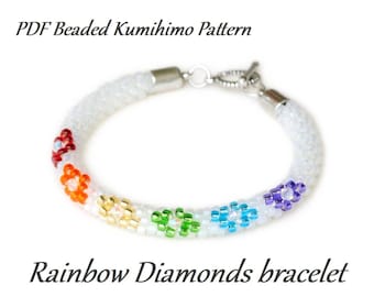 May include: A white beaded bracelet with a silver clasp and rainbow colored flower accents.  PDF Beaded Kumihimo Pattern. Rainbow Diamonds bracelet.