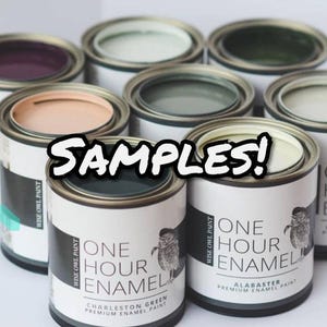 May include: A collection of small paint cans with various colors, including green, white, and purple. The cans are labeled "One Hour Enamel" and "Wise Owl Paint." The word "SAMPLES!" is displayed across the image.