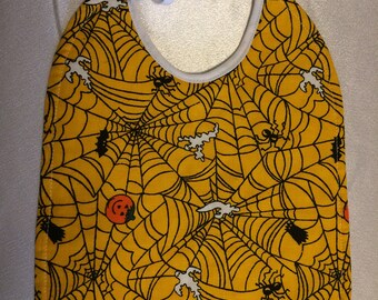 Halloween Baby Bib! Spiders! Ghosts! Pumpkin! Yellow Webbed Background White Quilted Backing. Cotton.