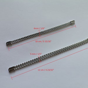 May include: Two silver chains with measurements in inches and centimeters. The top chain is 4 mm thick and 10 cm long. The bottom chain is 5 mm thick and 12 cm long.