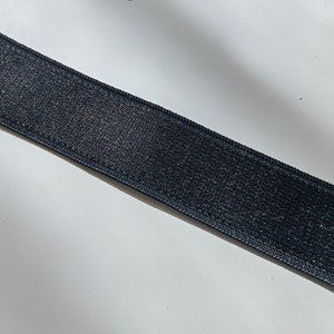 May include: Black elastic band with a textured surface.