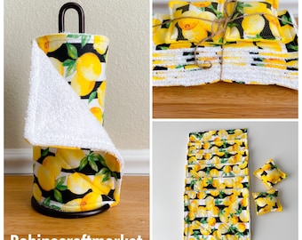 May include: A set of lemon-themed kitchen towels, including a roll of paper towels, a set of dishcloths, and two hand towels. The towels feature a black and white striped pattern with yellow lemons and green leaves. The text "Robinscraftmarket" is visible in the bottom left corner of the image.