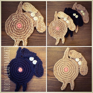 May include: Four crocheted dog coasters in brown and black with pink centers and white buttons for eyes. The coasters are shaped like dogs with floppy ears and tails.