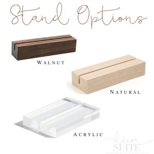 May include: Three different stand options for displaying cards or signs. The stands are made of walnut wood, natural wood, and clear acrylic. The stands are all rectangular in shape and have a slot in the middle for holding a card or sign.