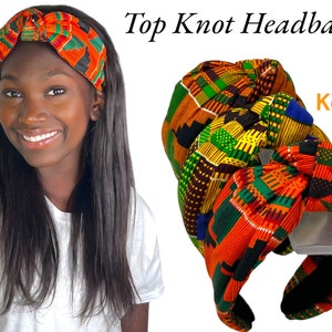May include: A woman wearing a colourful top knot headband. The headband features a vibrant Kente cloth pattern in orange, green, and black. The image also shows several other headbands with similar patterns. Text on the image reads "Top Knot Headbands" and "Kente".