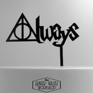 May include: Black cake topper featuring the words "Always" and a triangle with a circle inside, representing the Deathly Hallows symbol from the Harry Potter series.