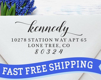 May include: A white envelope with a blue ribbon that says "FAST FREE SHIPPING". The envelope has a return address label with the name "kennedy", the address "10278 STATION WAY APT 65 LONE TREE, CO 80324", and a blue flower bouquet.