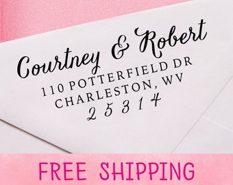 May include: A white envelope with a black return address stamp that reads "Courtney & Robert 110 Potterfield Dr Charleston, WV 25314". The envelope has a pink background with the words "FREE SHIPPING" printed in white.