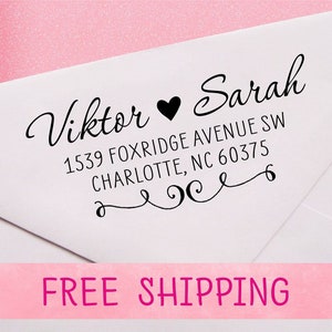 May include: A white envelope with a black return address stamp that reads "Viktor ♥ Sarah 1539 Foxridge Avenue SW Charlotte, NC 60375". The stamp has a decorative flourish.