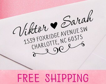 May include: A white envelope with a black return address stamp that reads "Viktor ♥ Sarah 1539 Foxridge Avenue SW Charlotte, NC 60375". The stamp has a decorative flourish.