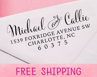 May include: A white envelope with a black ink return address stamp that reads "Michael and Callie, 1539 Foxridge Avenue SW, Charlotte, NC 60375". The envelope has a pink background.