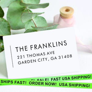 May include: White card with black text that reads "THE FRANKLINS", "221 THOMAS AVE", and "GARDEN CITY, GA 31408".
