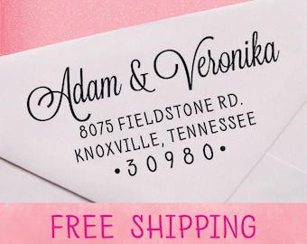 May include: A white envelope with a black return address label. The label reads "Adam & Veronika", "8075 Fieldstone Rd.", "Knoxville, Tennessee", and "30980."