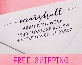 May include: A white envelope with a black return address label that reads "marshall BRAD & NICHOLE 1539 FOXRIDGE RUN SW WINTER HAVEN, FL 33880". The envelope has a pink strip across the bottom that reads "FREE SHIPPING".