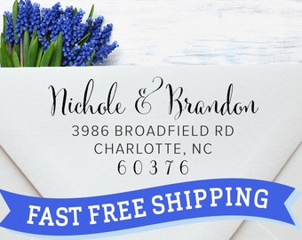May include: White envelope with a blue ribbon banner that says "FAST FREE SHIPPING". The envelope has a return address that reads "Nichole & Brandon, 3986 Broadfield Rd, Charlotte, NC 60376".