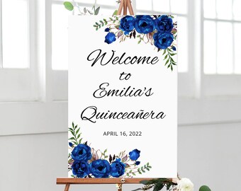 May include: Welcome to Emilia's Quinceañera sign with blue floral decorations and the date April 16, 2022.