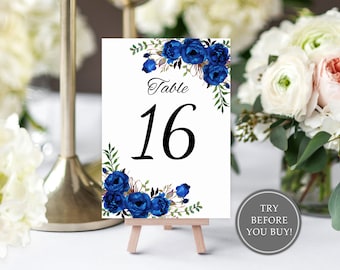 May include: Blue floral wedding table number card with the number 16 printed in black. The card is on a small wooden easel.
