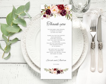 May include: A thank you card with a floral design in shades of burgundy, pink, and green. The text reads "Thank you" and includes a message of gratitude to family and friends. The card is signed "Sarah and Andrew" and dated "10.12.2022".