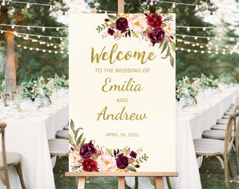 Könnte beinhalten: Ein Willkommens-Schild für eine Hochzeit mit burgunderfarbenen und rosafarbenen Blumenillustrationen. Das Schild lautet "Willkommen zur Hochzeit von Emilia und Andrew, 16. April 2022".