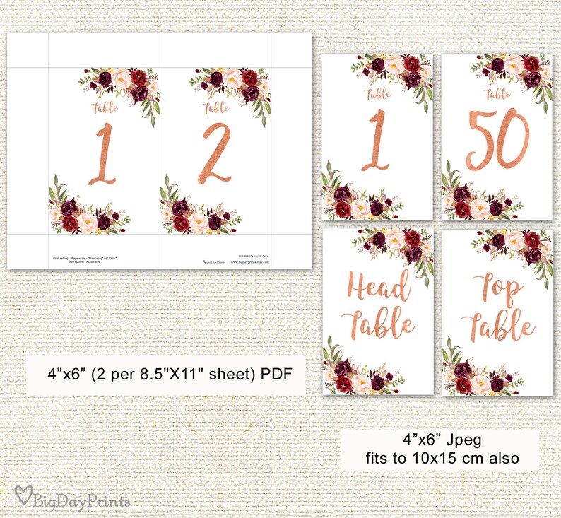May include: White table number cards with copper-colored numbers and text. Each card features floral arrangements in burgundy, cream, and green. The cards are labeled "Table 1", "Table 2", "Table 50", "Head Table", and "Top Table".