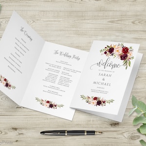 May include: A wedding ceremony programme with a burgundy and blush floral design. The programme includes the order of the ceremony and the wedding party. The welcome card features the same floral design and the names Sarah & Michael.