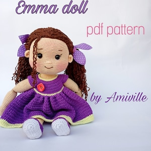 May include: A handmade crochet doll named "Emma" wearing a purple dress with yellow trim and a red flower. The doll has brown curly hair, purple polka dot bows, and white shoes. The text "pdf pattern by Amiville" is also visible.