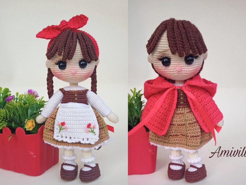 May include: Two crochet dolls, one with a red bow and braids, wearing a white blouse, brown vest, and apron with floral embroidery. The other doll wears a red hooded cape. Both dolls have brown shoes.