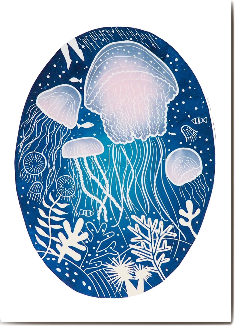 May include: An oval-shaped art print featuring a deep blue background with white and light blue jellyfish, fish, and coral. The jellyfish have delicate, flowing tentacles and a soft pink hue in their bells. The artwork has a whimsical, underwater theme.