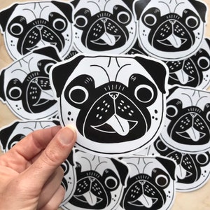 May include: A set of black and white pug stickers. The pugs are drawn in a cartoon style with big eyes and a tongue sticking out. The stickers are perfect for adding a touch of personality to laptops, water bottles, or notebooks.